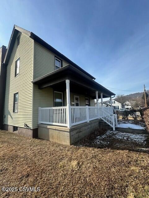 view of property exterior featuring covered porch