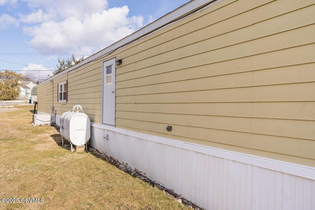 view of side of home with a yard