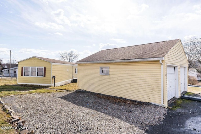 view of side of property featuring a garage and an outdoor structure