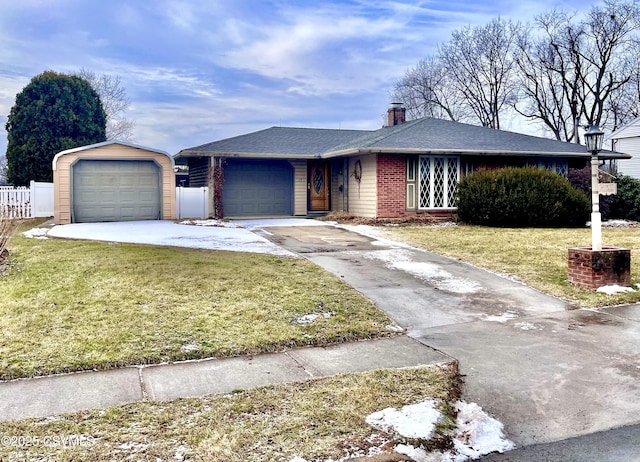 ranch-style home with a garage and a front lawn