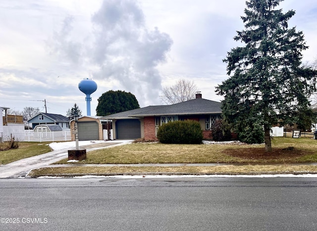 view of front of property with a garage and a front lawn