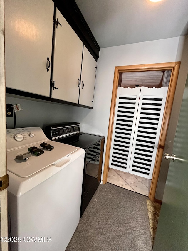 washroom with cabinets, washing machine and dryer, and light tile patterned flooring