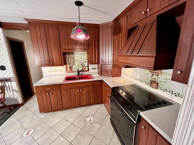 kitchen with pendant lighting, sink, light tile patterned floors, tasteful backsplash, and black electric range