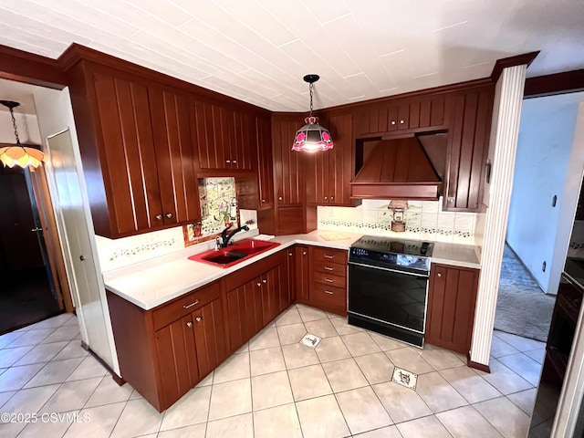 kitchen with sink, light tile patterned floors, premium range hood, hanging light fixtures, and black range with electric cooktop