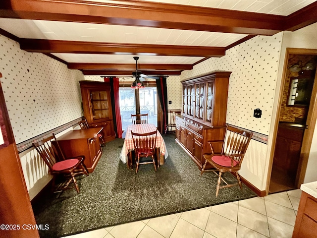 dining space with beamed ceiling and light tile patterned floors