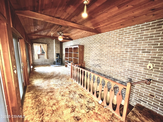 hallway with brick wall, vaulted ceiling with beams, wood ceiling, and carpet flooring