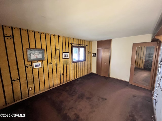 basement featuring dark colored carpet