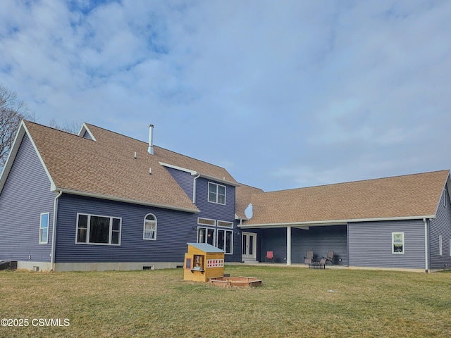 rear view of house with a lawn and a patio area