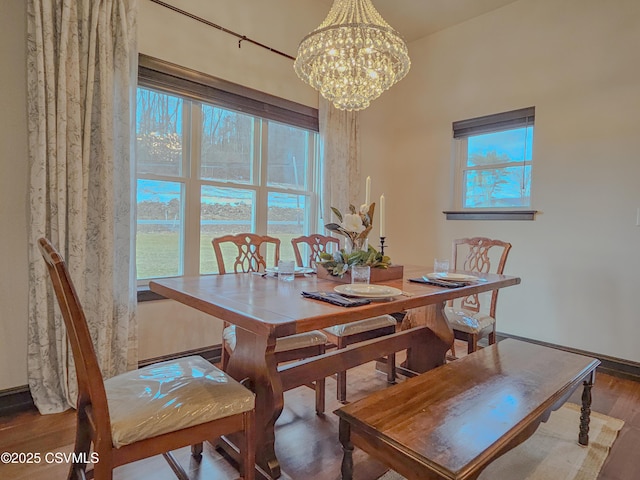 dining room with hardwood / wood-style flooring and a notable chandelier