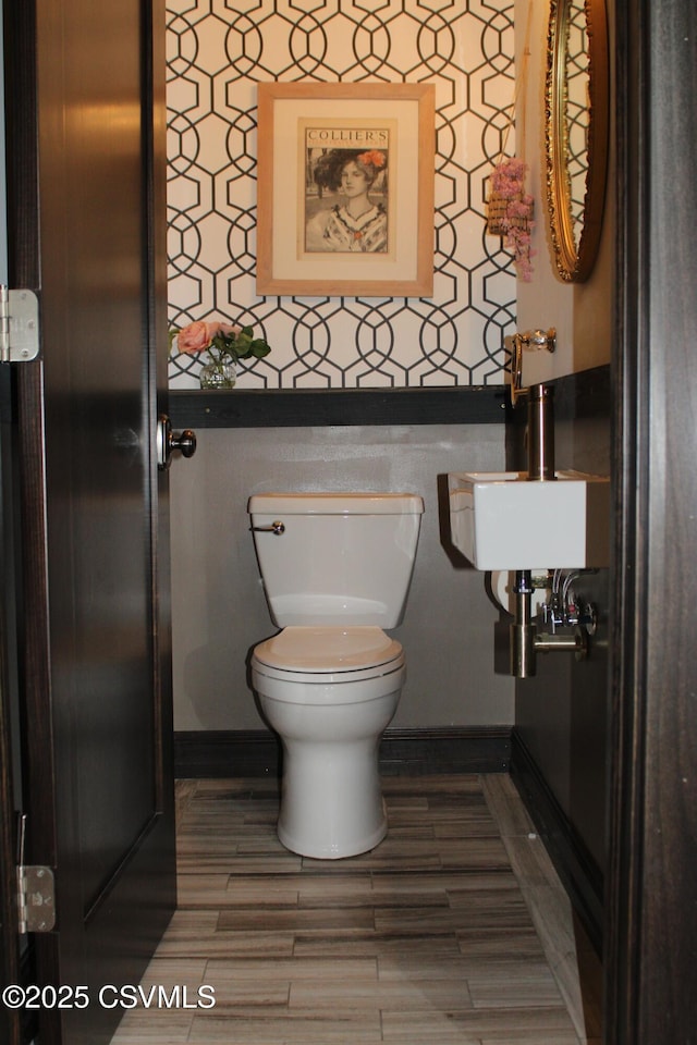 bathroom featuring sink, toilet, and hardwood / wood-style floors