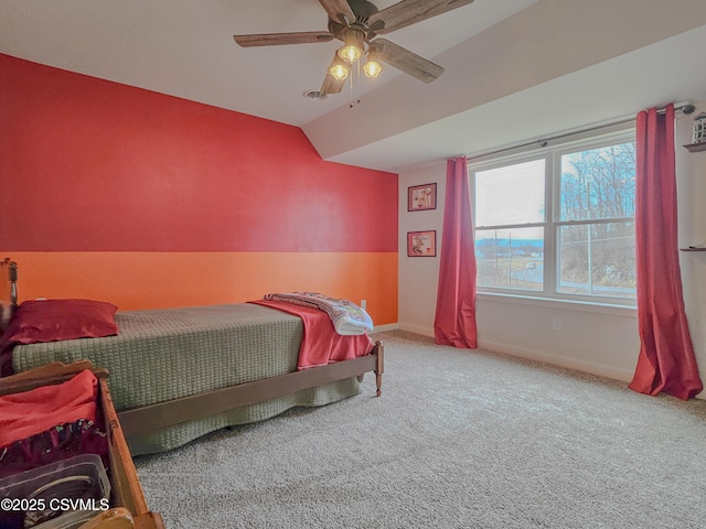 bedroom with ceiling fan, vaulted ceiling, and carpet