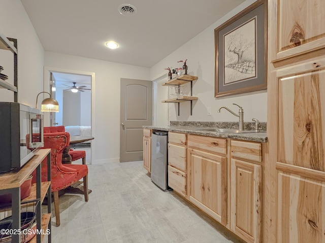 kitchen featuring sink, stainless steel dishwasher, and light brown cabinets