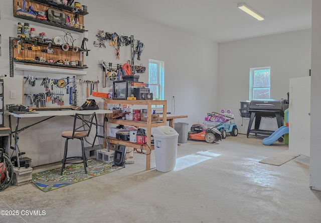 interior space featuring concrete flooring and a workshop area