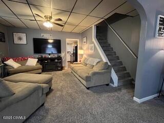 carpeted living room with a paneled ceiling and ceiling fan