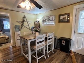 dining room featuring ornamental molding, dark wood-type flooring, radiator, and ceiling fan