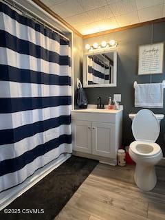 bathroom with walk in shower, wood-type flooring, toilet, and vanity