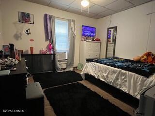 bedroom with a drop ceiling and ceiling fan