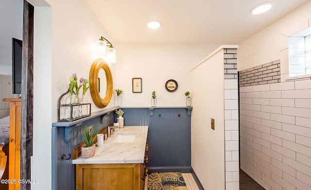 bathroom featuring vanity and tiled shower