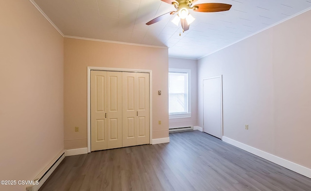 unfurnished bedroom featuring ornamental molding, dark hardwood / wood-style floors, and baseboard heating