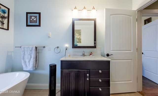 bathroom with vanity and a bath