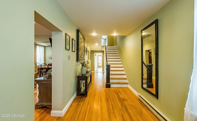 hall featuring a baseboard radiator and wood-type flooring