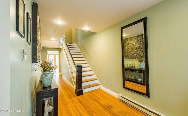 interior space with hardwood / wood-style floors and a baseboard heating unit