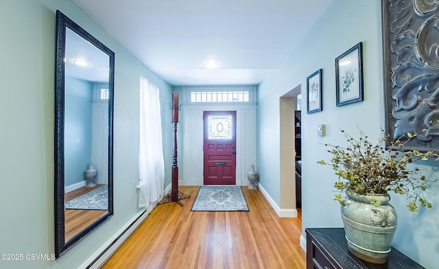 entryway with a baseboard radiator and hardwood / wood-style floors