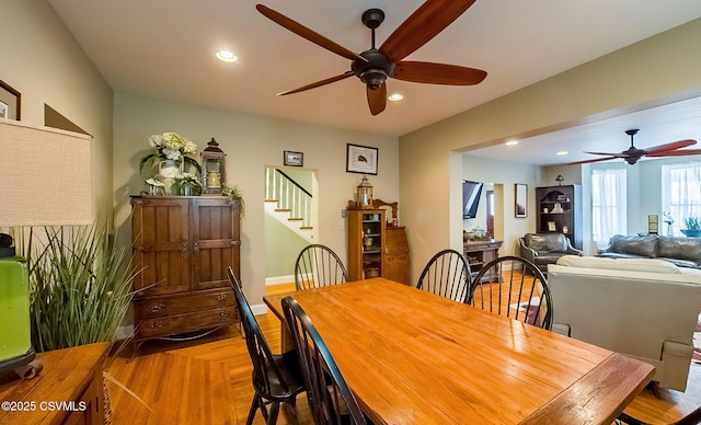 dining room featuring ceiling fan and parquet flooring