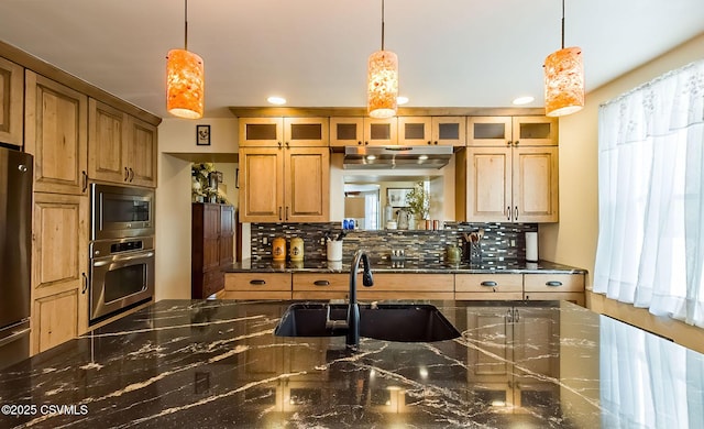 kitchen featuring stainless steel appliances, sink, and decorative light fixtures