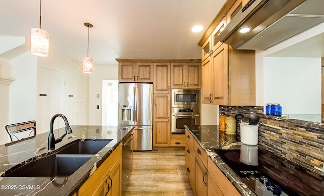 kitchen featuring dark stone countertops, ventilation hood, sink, and black appliances