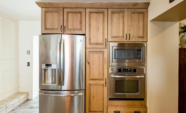 kitchen featuring light tile patterned flooring and appliances with stainless steel finishes