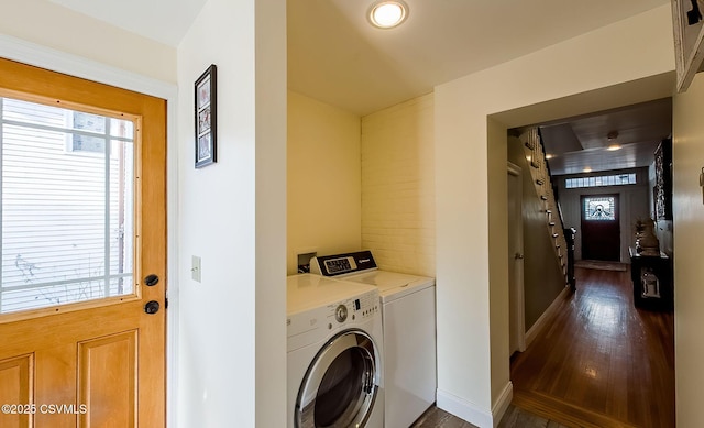 laundry area featuring dark wood-type flooring and independent washer and dryer