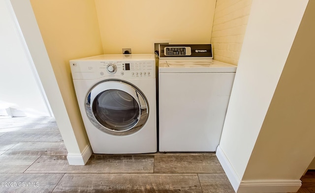 clothes washing area with independent washer and dryer