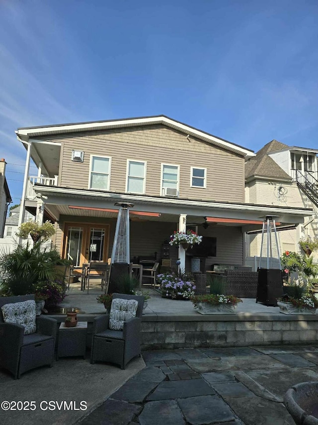 rear view of property featuring a patio