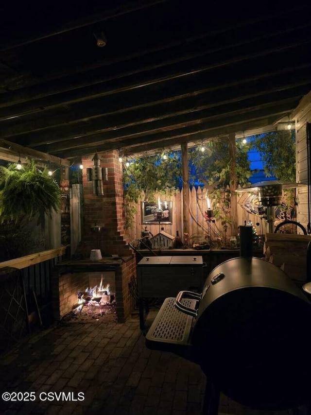 patio at twilight featuring a fireplace