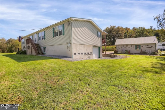 view of side of property featuring a garage and a yard