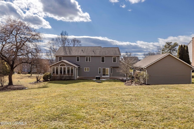 back of property with a lawn and a sunroom