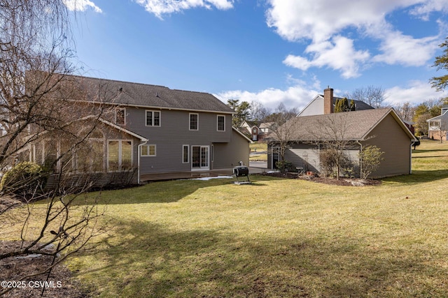 rear view of property with a lawn