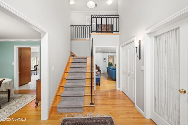 stairway featuring hardwood / wood-style floors and a towering ceiling