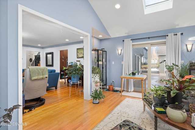 entryway featuring wood-type flooring and vaulted ceiling with skylight