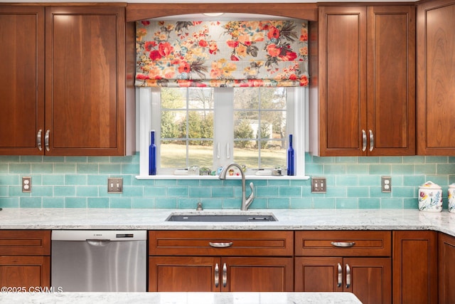 kitchen featuring tasteful backsplash, dishwasher, sink, and light stone counters