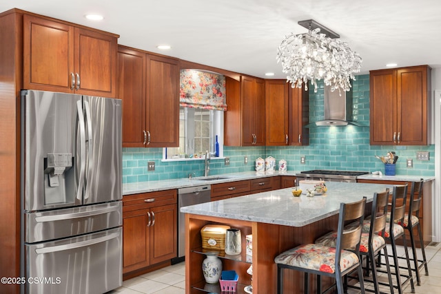 kitchen featuring sink, stainless steel appliances, a center island, light stone countertops, and wall chimney exhaust hood