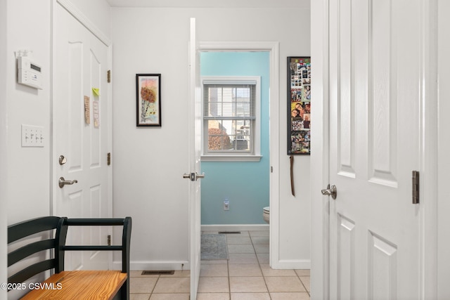 hallway with light tile patterned floors