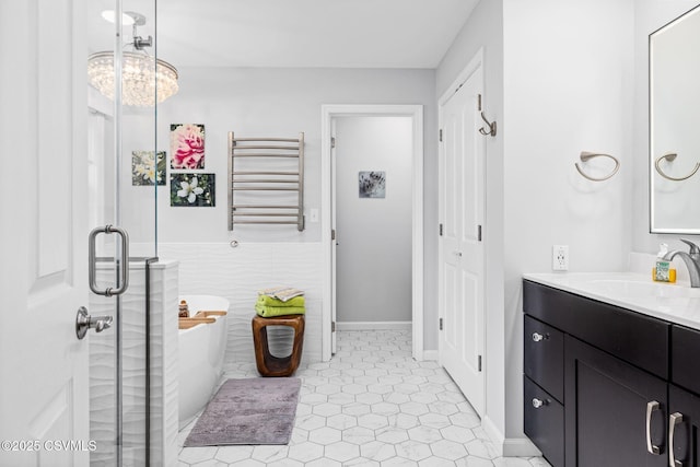 bathroom with shower with separate bathtub, radiator, tile walls, vanity, and tile patterned floors