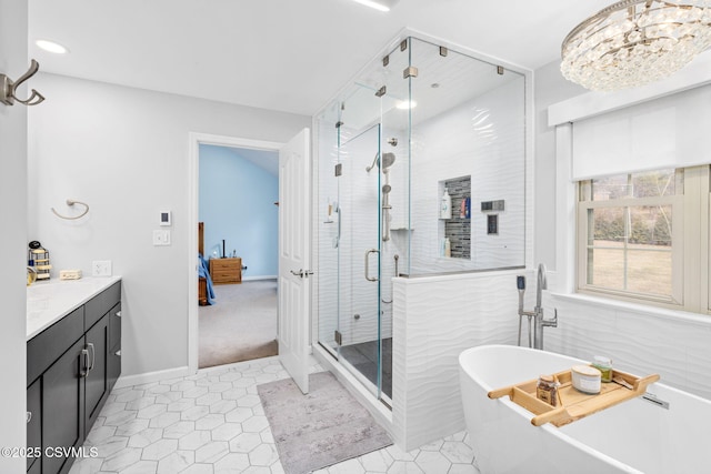 bathroom with shower with separate bathtub, tile walls, vanity, and tile patterned floors