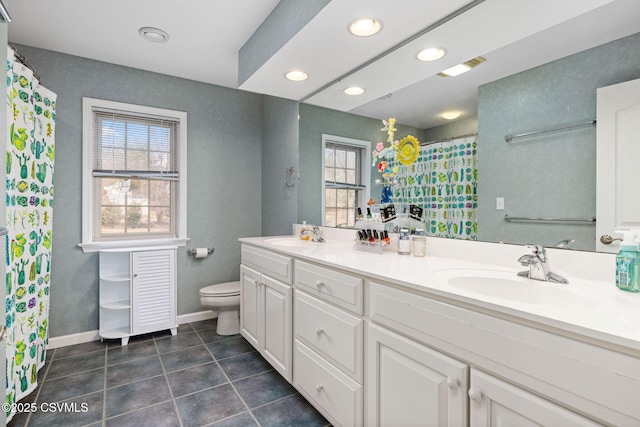 bathroom with tile patterned flooring, vanity, and toilet