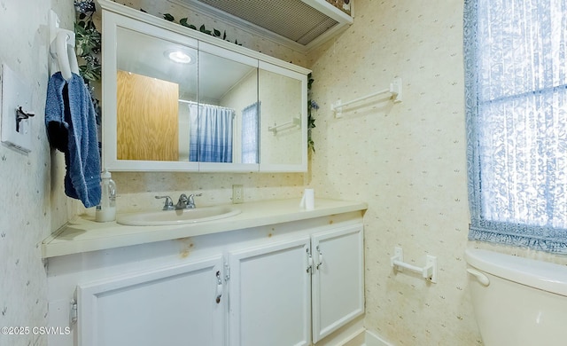 bathroom with vanity, toilet, and a shower with shower curtain