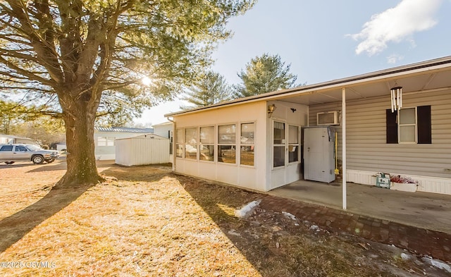 view of side of home featuring a sunroom