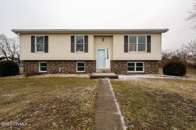 split foyer home with a front lawn