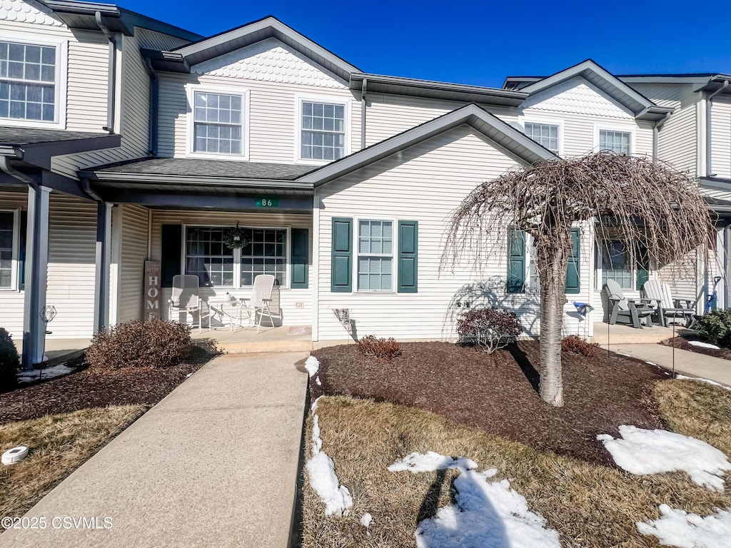 townhome / multi-family property featuring a porch